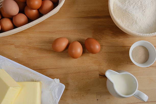 Elevated view of fresh, brown eggs on wooden table