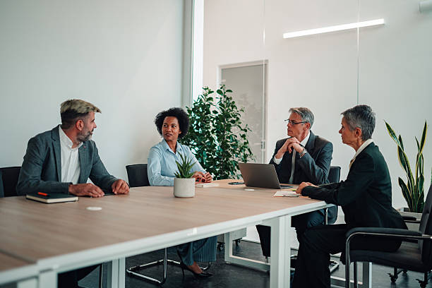 istock Business professionals collaborating at modern office meeting 2245618551
