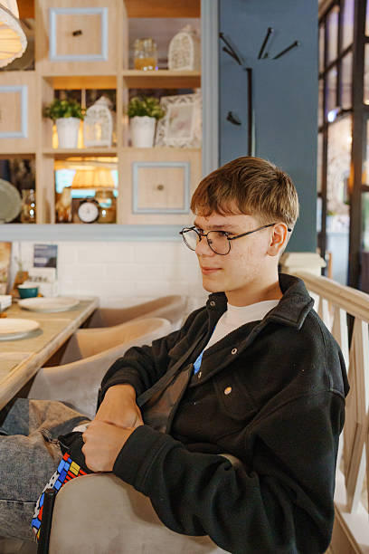 Young man relaxing in a cozy cafe setup