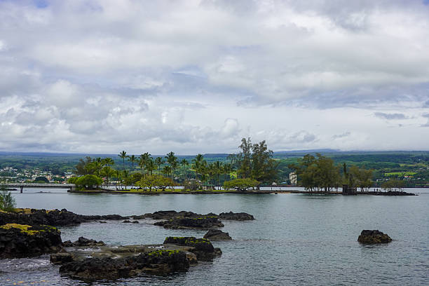 istock Rocky tropical shoreline with distant coastal town 2245619639