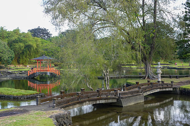 istock Tranquil Japanese style garden with pond and red pavilion 2245619880