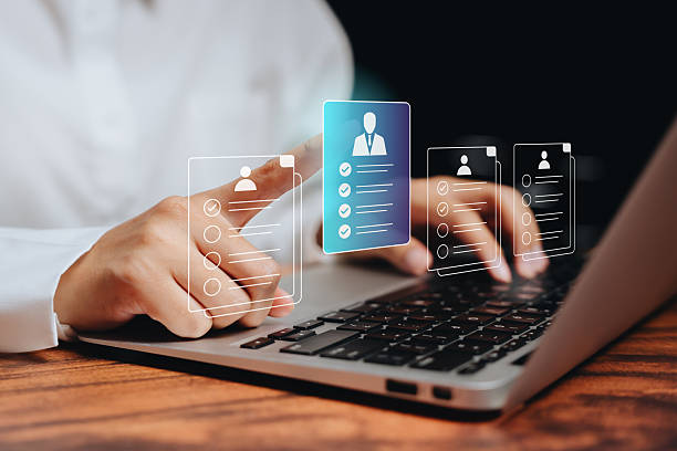istock Recruitment concept. HR manager using laptop with virtual candidate profiles, digital resume selection, and human resource management technology. 2245619908