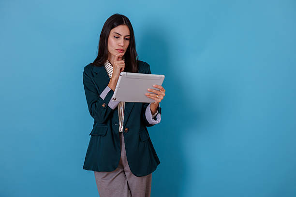 istock Businesswoman thinking, using digital tablet for remote work or online studying, finding solution 2245624744