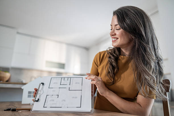 istock Real estate agent discussing new house floor plan 2245627550