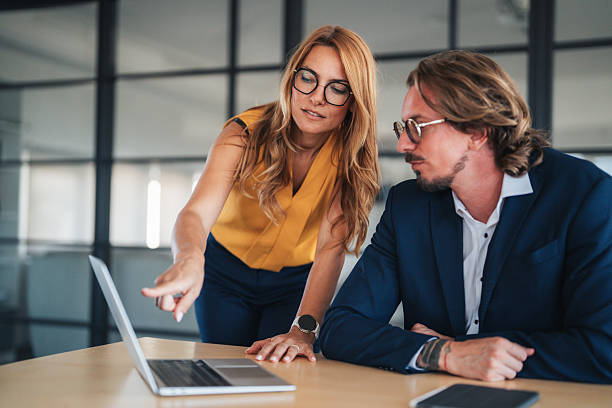 istock Business colleagues communicating and collaborating in an office 2245628383