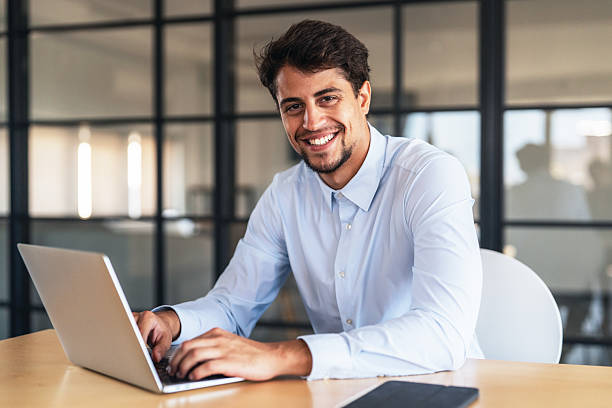 istock Confident young businessman managing work online 2245628415