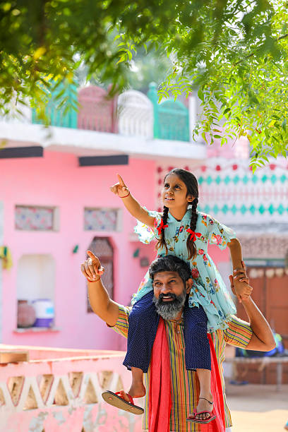istock Happy indian farmer with daughter at home 2245630783
