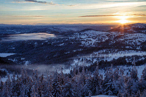 istock Breathtaking sunset over endless snowy forest in Nordic mountains 2245630844