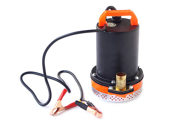 istock Small submersible water pump with DC electric clips for battery connection, used for transferring water or draining. Portable design suitable for outdoor, agricultural, and emergency applications. 2245636655