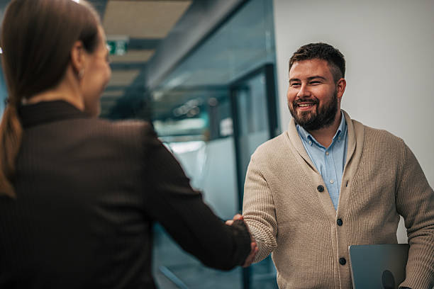 istock Business colleagues shaking hands making a deal 2245639898