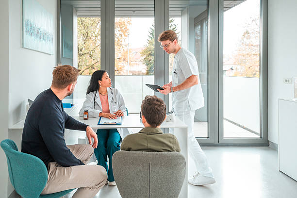 istock Caucasian Father Engaging with Multiracial Son During Doctor Appointment 2245641076