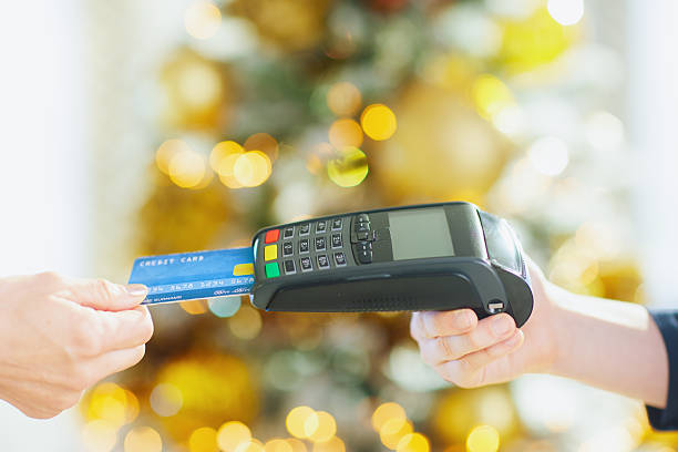istock Inserting Blue Credit Card for Holiday Purchase 2245642763