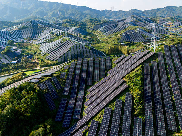 istock Solar panels and power towers on the hillside 2245645713