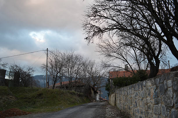 istock Moody winter mountain village road under dramatic cloudy sky in Greece 2245646464