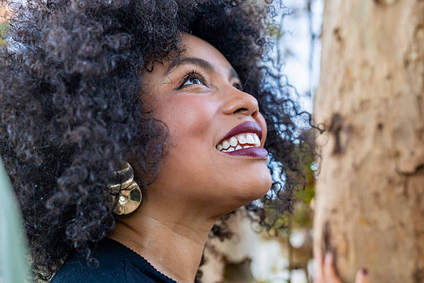 istock Happy black woman looking up enjoying nature 2245649989