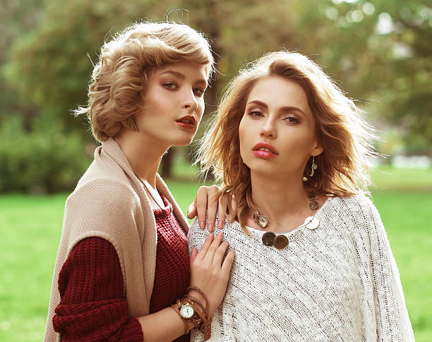 Autumn. Photo of a two beautiful women in the park.
