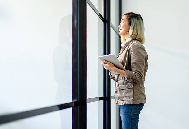 istock female architect engineer holding tablet standing near window 2245654215