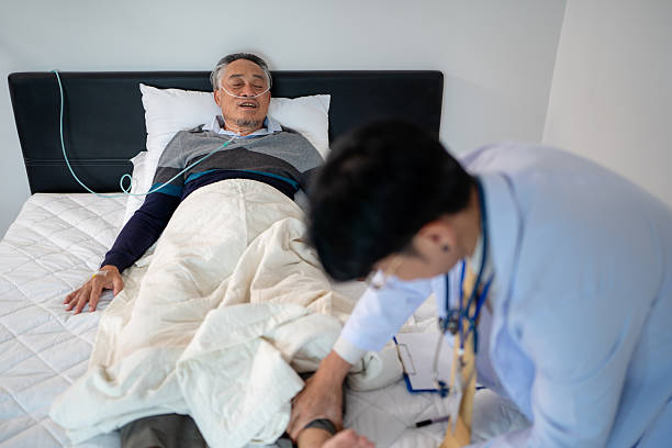 istock scene of doctor checking bedridden patient symptom 2245654666