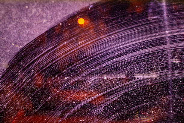 istock dirty streaks from the windshield cleaner on the windshield at night behind the car, blinding from the headlights of oncoming traffic 2245655748