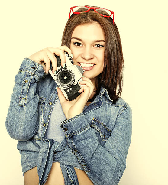 istock young pretty woman holding camera 2245656157