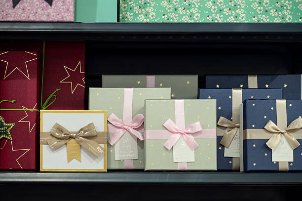 istock Colorful gift boxes with ribbons on store shelf 2245670289