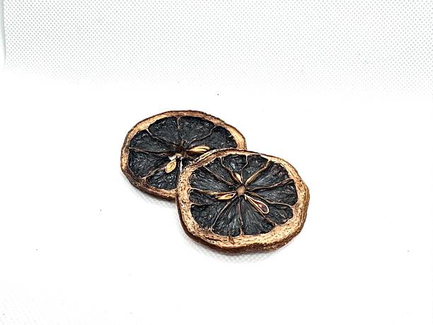 istock Dried lemon slices with rustic appearance on white background, ideal for culinary decoration, baking, crafts, and natural aroma applications 2245674798