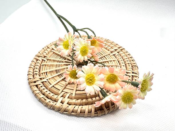 istock Delicate pastel flowers arranged on a round woven mat showcasing natural textures and soft hues perfect for home decor or floral design projects 2245676489