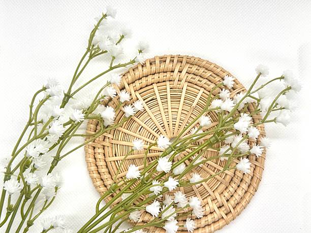 istock White flowers arranged on a round woven wicker basket creating an elegant natural decor concept with a soft neutral background aesthetic 2245676495