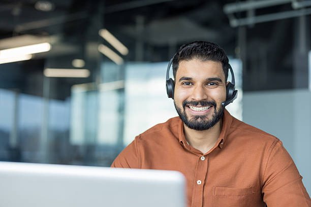 istock Smiling customer service agent wearing headset in office 2245676592