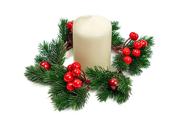 Christmas candle with pine branches and red berries on white background
