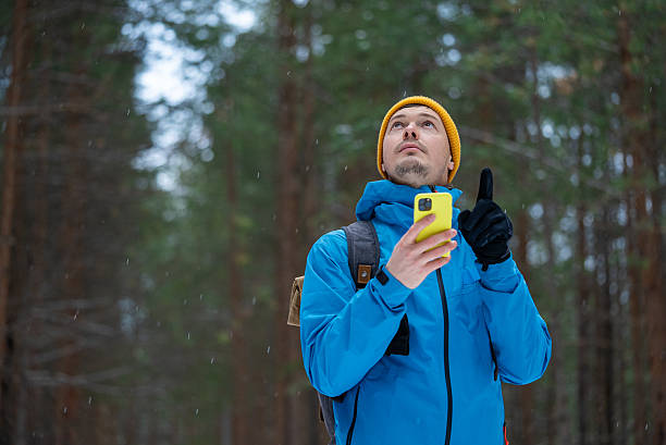 istock Hiker navigating forest path using smartphone, man looking up, lost in wilderness, concept of orientation, technology, travel and survival challenge in winter wood 2245678140