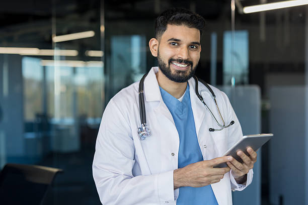 istock Professional indian doctor smiling, holding digital tablet 2245681293