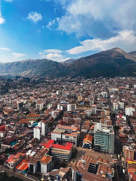 istock City on mountain slope under clouds (aerial) 2245681570