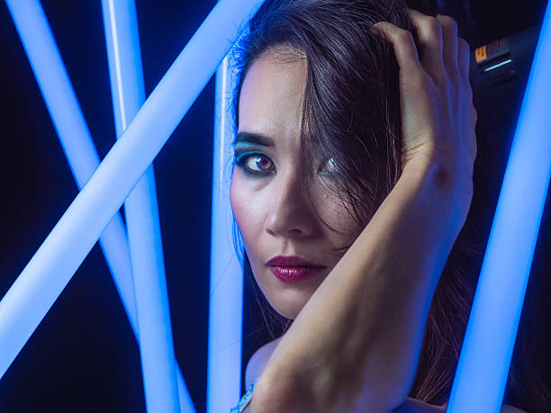 Stylized portrait of an Asian woman under neon lighting. Fashion-forward scene blending beauty, style, and modern visual aesthetics.