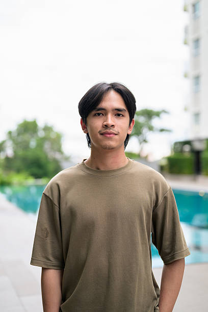 istock Portrait of handsome Young Asian Thai man outdoors next to swimming pool during summer 2245683081