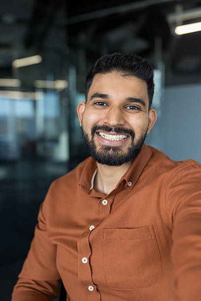 istock Confident indian businessman smiling, doing a selfie portrait 2245684556