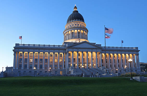 istock State Capitol illuminated at dusk with green grass on the foreground 2245684718