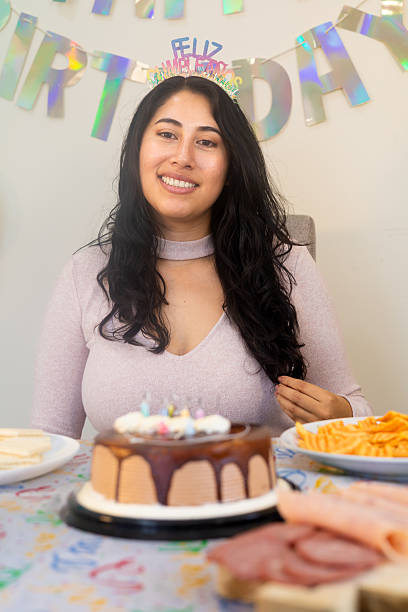 istock Woman enjoying birthday celebration with cake and snacks 2245684964