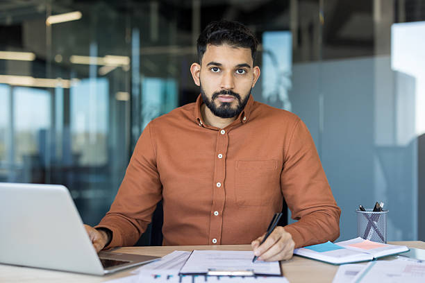 istock Indian businessman working on laptop checking documents in office 2245686227