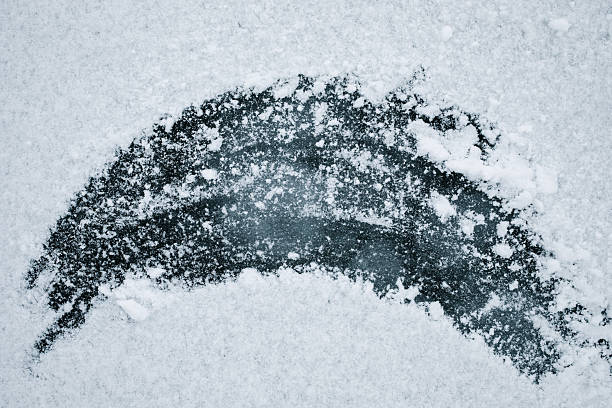Ice surface covered with snow abstract background. Winter natural texture blank or pattern of deep blue frozen water.