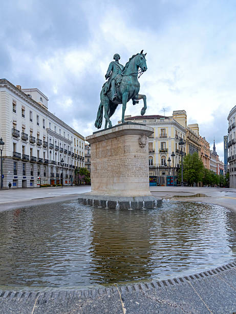 istock Historic Statue Reflected In Puerta Del Sol Water 2245690417