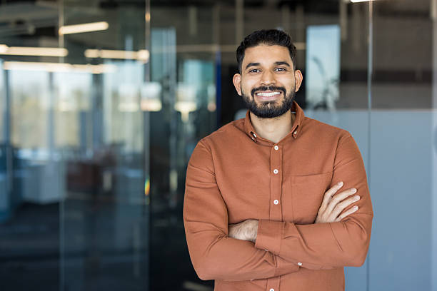 istock Confident indian businessman smiling, posing in modern office 2245690623