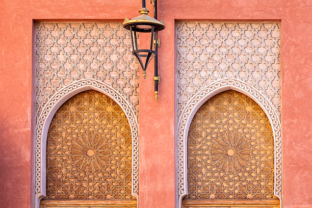istock Moroccan architecture in Marrakech medina, featuring carved arched doors, geometric Islamic patterns, and a lantern beneath ornate wooden details. 2245694825