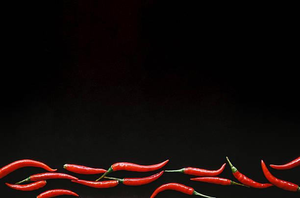 istock frame of fresh red chilli on black background with copy space 2245696709