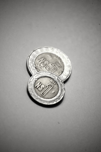 One old mexican one peso coin over five obe