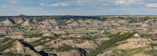 istock Badlands landscape with layered hills and sparse vegetation. 2245704436