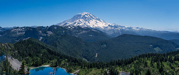 istock Mount Rainier towers over lush forests and pristine lakes. 2245704699