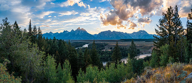 istock Grand Teton mountains, river, and forest at sunset. 2245704713
