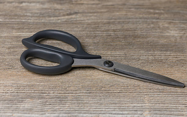 istock Kitchen Scissors on Wooden Table in Soft Natural Light 2245707432