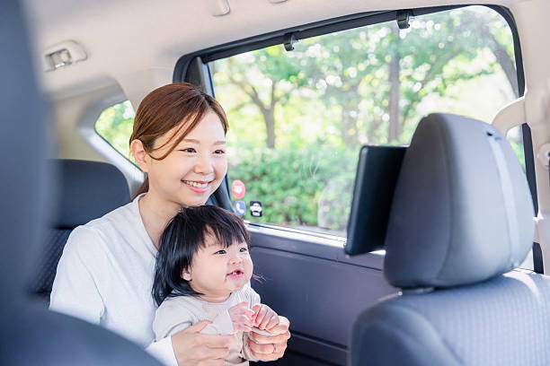 istock A mother riding in a cab with her small child 2245709248